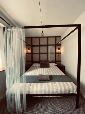 a bedroom with a bed with a canopy at Shore Cottage in Girvan