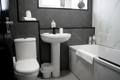 a bathroom with a white toilet and a sink at Calgary House in Livingston
