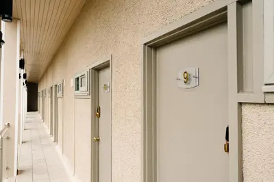 a row of doors in a hallway of a building at Powfoulis Inn in Falkirk