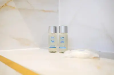 two bottles ofodorizers sitting on a bathroom counter at Powfoulis Inn in Falkirk