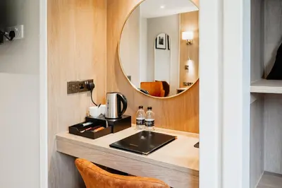 a bathroom with a sink and a mirror at Powfoulis Inn in Falkirk