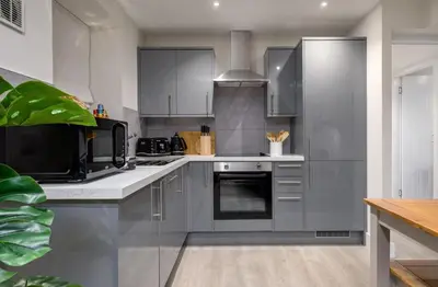 a kitchen with stainless steel cabinets and appliances at Central Stirling City Escape in Stirling