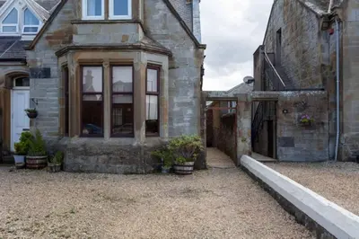 an external view of a house with a driveway at St Meddans Mews in Troon in Troon