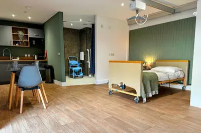 a bedroom with a bed and a kitchen with a desk at Modern Accessible Apartment with Interconnecting Room in Dolphinton