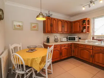 a kitchen with a table and a microwave at Mousebank in Lanark