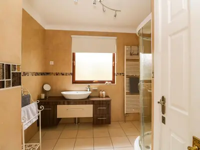 a bathroom with a sink and a mirror at Mousebank in Lanark