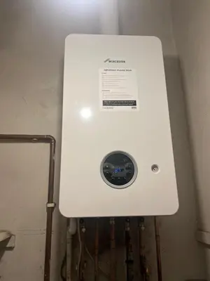 a white electrical box in a room with pipes at One Bedroom Apartment in Gorgie with new central heating system in Edinburgh