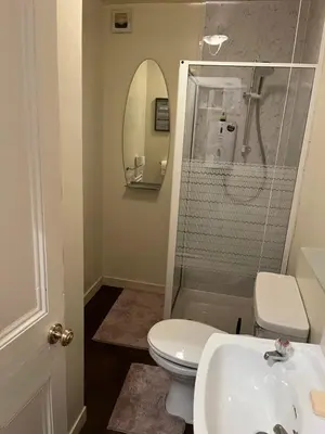 a bathroom with a toilet and a sink and a mirror at Our Wee Eden - Rothesay in Rothesay