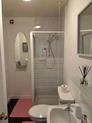 a bathroom with a shower and a toilet and a sink at Our Wee Eden - Rothesay in Rothesay