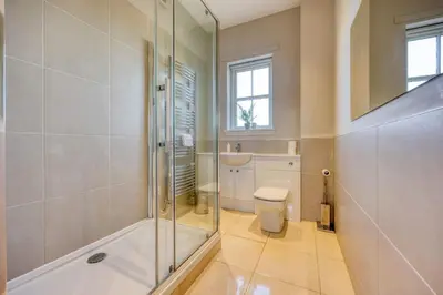 a bathroom with a shower and a toilet at Stunning 4 Bedroom Farmhouse in Bishopton