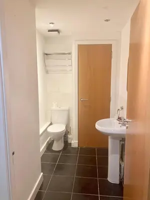 a bathroom with a toilet and a sink at Duplex Apartment in Glasgow