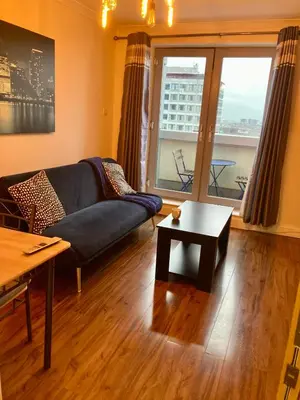 a living room with a couch and a table at Duplex Apartment in Glasgow