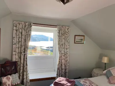 a bedroom with a window with a view of the water at Little cottage-Village of Bunessan-Sleeps4 in Bunessan