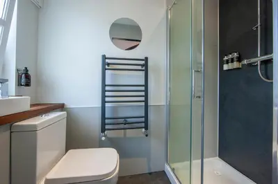 a bathroom with a toilet and a shower at Exceptional 2BD Apt - next to ferry & train station in Oban