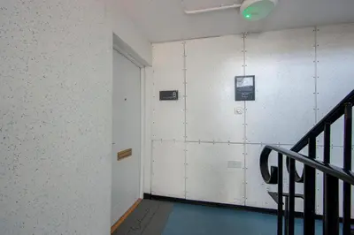 an empty hallway with a door and a staircase at Exceptional 2BD Apt - next to ferry & train station in Oban