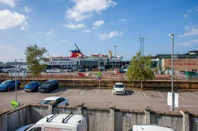 a parking lot with a bunch of cars parked at Exceptional 2BD Apt - next to ferry & train station in Oban