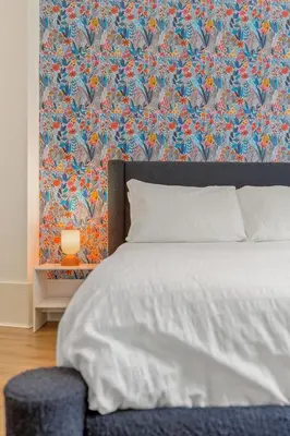 a bedroom with a bed with a floral wallpaper at Woodford Street in Mansewood