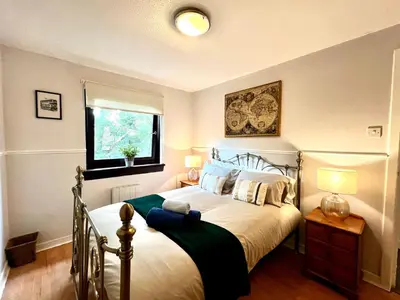 a bedroom with a bed and a window at Cityview Retreat - 2-Bed Apartment - Free Parking in Glasgow