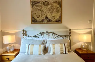 a bedroom with a bed with two lamps and a picture on the wall at Cityview Retreat - 2-Bed Apartment - Free Parking in Glasgow