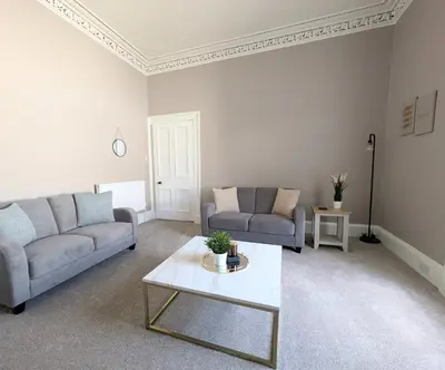 a living room with two couches and a coffee table at Campbeltown Retreat in Campbeltown
