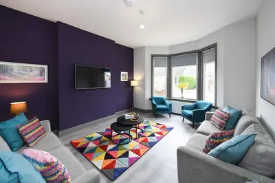a living room with a couch and a table at Diamond House - 4 bedroom luxury home in Airdrie