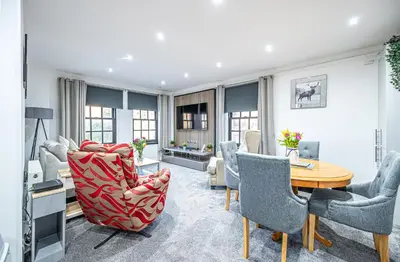 a living room with a table and chairs at Super Prime Abbey Free Parking by TBA in Dunfermline