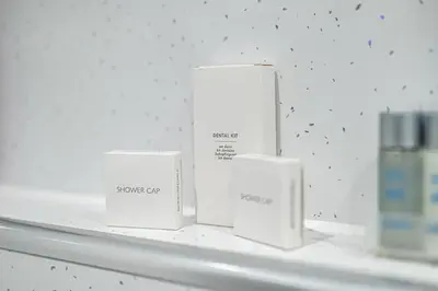 four white boxes on a shelf in a room at Super Prime Abbey Free Parking by TBA in Dunfermline