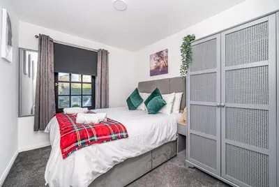 a bedroom with a bed and a window at Super Prime Abbey Free Parking by TBA in Dunfermline