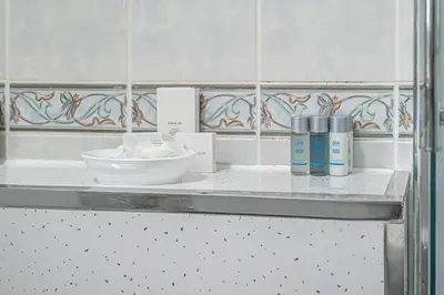 a bathroom counter with a sink and some products on it at Pure Home Rosyth Dockyard by TBA in Rosyth