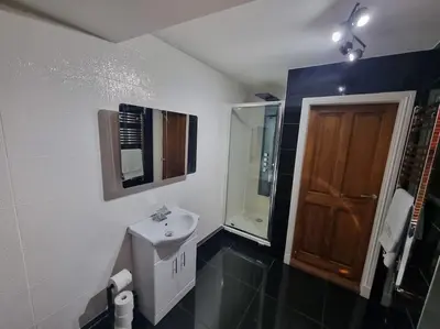 a bathroom with a sink and a mirror at Mafeking Place Apartment in Campbeltown