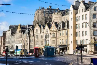 a row of buildings in front of a castle at Castle View Retreat in Edinburgh