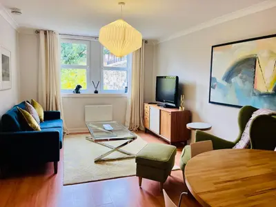 a living room with a couch and a table at Castle View Retreat in Edinburgh