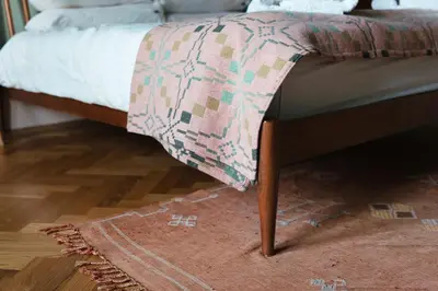a bed with a blanket on the foot board at Beautiful central Edinburgh Apartment in Edinburgh