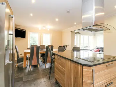 a kitchen and dining room with a dining table at Taighean Anndra in Killin