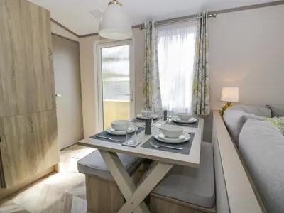 a living room with a table and a couch at 11A Mansion View in Helensburgh