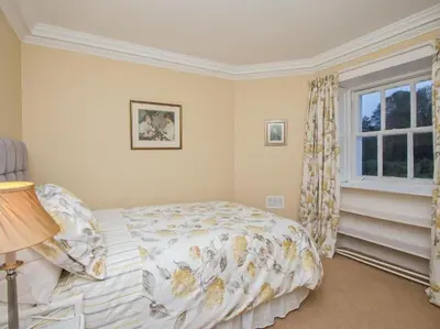 a bedroom with a bed and a window at Country Home on Private Estate in Minishant