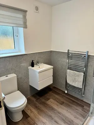 a bathroom with a toilet and a sink at Inchcruin Apartment - Macaulay Letting in Bonhill