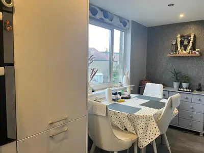 a kitchen with a table and chairs and a window at Room in a Home in Edinburgh