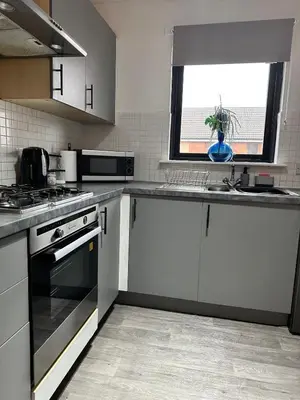 a kitchen with white appliances and a window in it at 2 Bed Entire Upper Cottage Flat in Central Glasgow in Glasgow