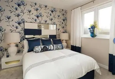 a bedroom with a bed with blue and white wallpaper at Entire 4 bed perfect family home in Glasgow in Nitshill