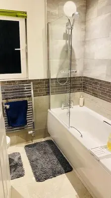 a bathroom with a tub and a shower and a toilet at Entire 4 bed perfect family home in Glasgow in Nitshill