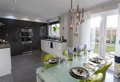 a kitchen with a glass table and green chairs at Entire 4 bed perfect family home in Glasgow in Nitshill