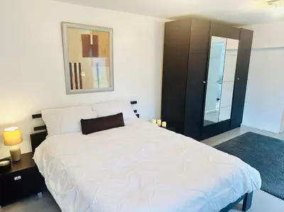 a bedroom with a large white bed and a mirror at Entire Private 1 Bedroom - Guest Suite in Glasgow in Glasgow