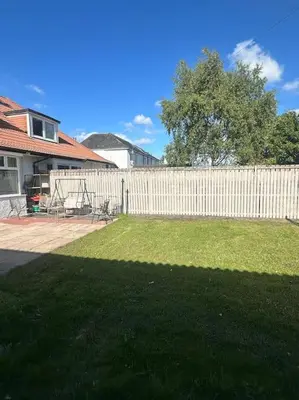 a white fence in front of a yard at Entire Private 1 Bedroom - Guest Suite in Glasgow in Glasgow