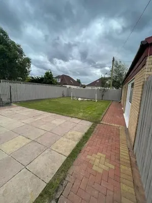 a backyard with a fence and a brick walkway at Entire Private 1 Bedroom - Guest Suite in Glasgow in Glasgow
