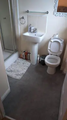 a bathroom with a toilet and a sink and a shower at Holytown Homes in Holytown