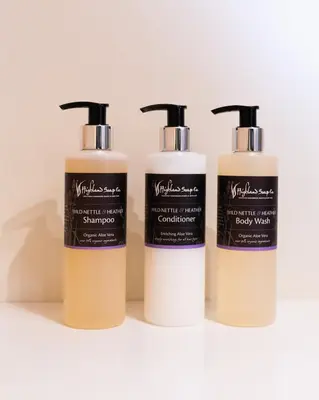 three bottles of hair products sitting on a shelf at Countryside Farm Pod on Isle of Seil - B in Balvicar