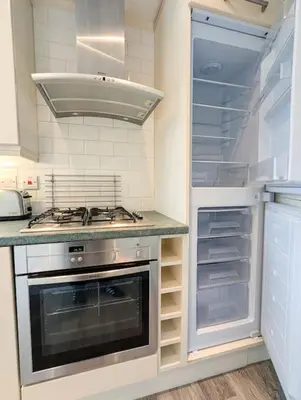 a kitchen with a stove and an empty refrigerator at Parkgate 2 bed, private parking, Rosyth M90 in Rosyth