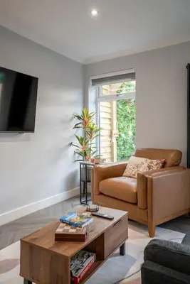 a living room with a couch and a coffee table at Cottage with Hot Tub near Knockhill in Saline