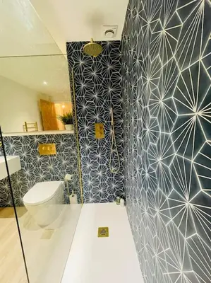 a bathroom with a toilet and a blue and white wall at Designer Studio in Edinburgh with Free Parking in Edinburgh